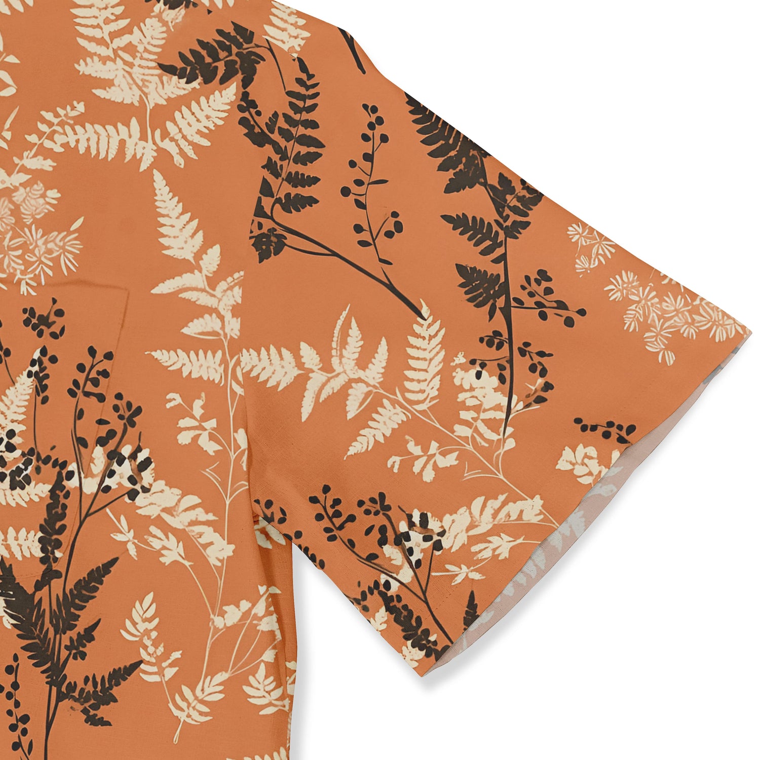 Close-up of a fern-patterned shirt in orange and brown.