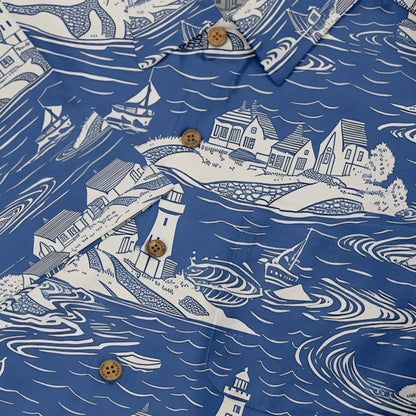 Lighthouse and sailing boat pattern on a blue background, perfect for seaside lovers.