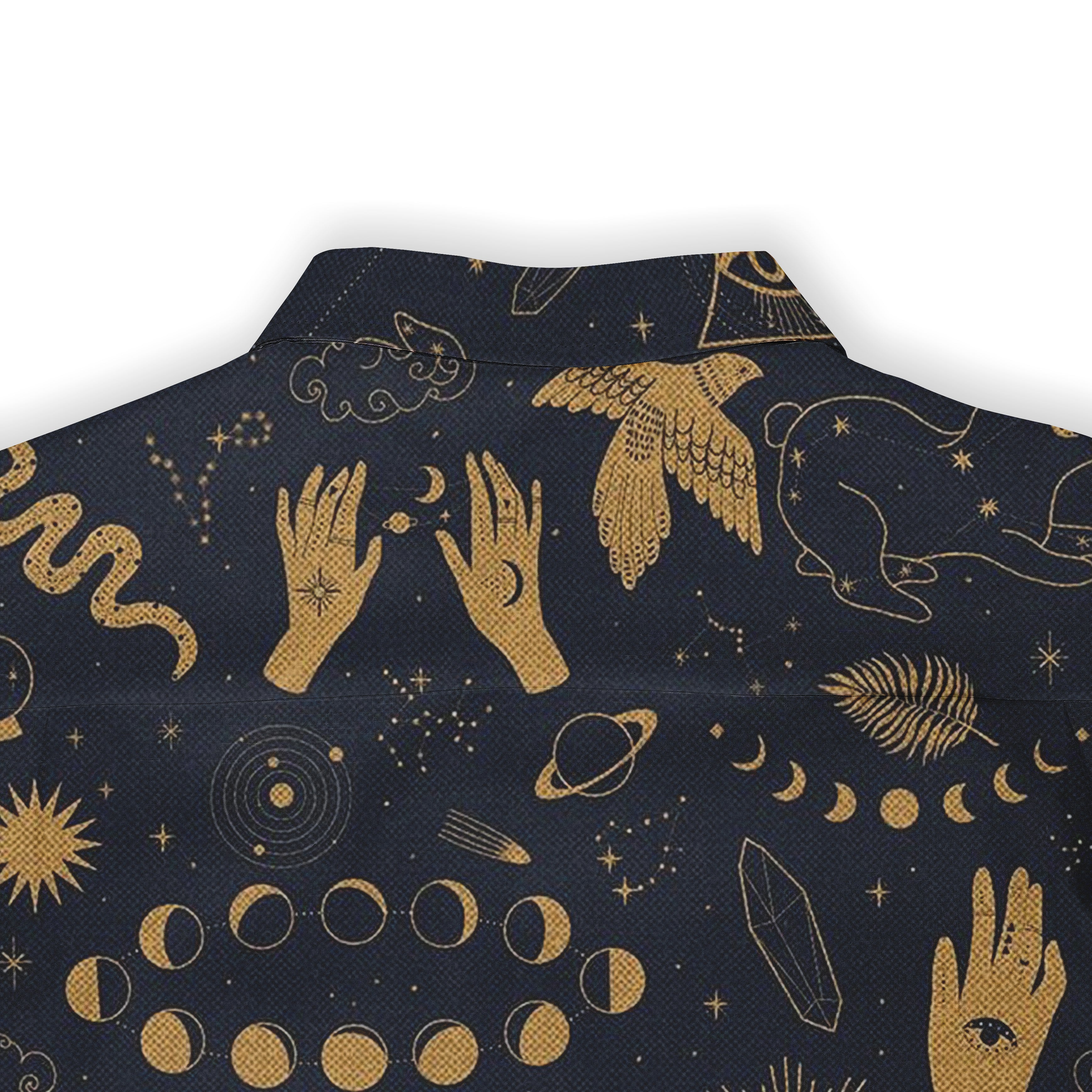 Back view of a shirt showcasing gold celestial and mystical designs on dark fabric, featuring hands, moons, and other cosmic symbols.