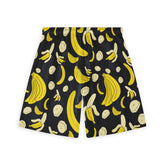 Back view of black shorts with a lively banana print, featuring whole bananas, peeled bananas, and slices in yellow and cream tones, adding a playful and vibrant touch to the design.