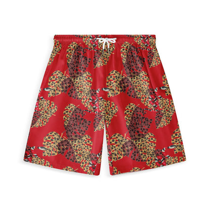 Hawaiian shorts with a vivid red background, featuring large, leopard-print leaves in yellow and brown tones, and subtle snake details.