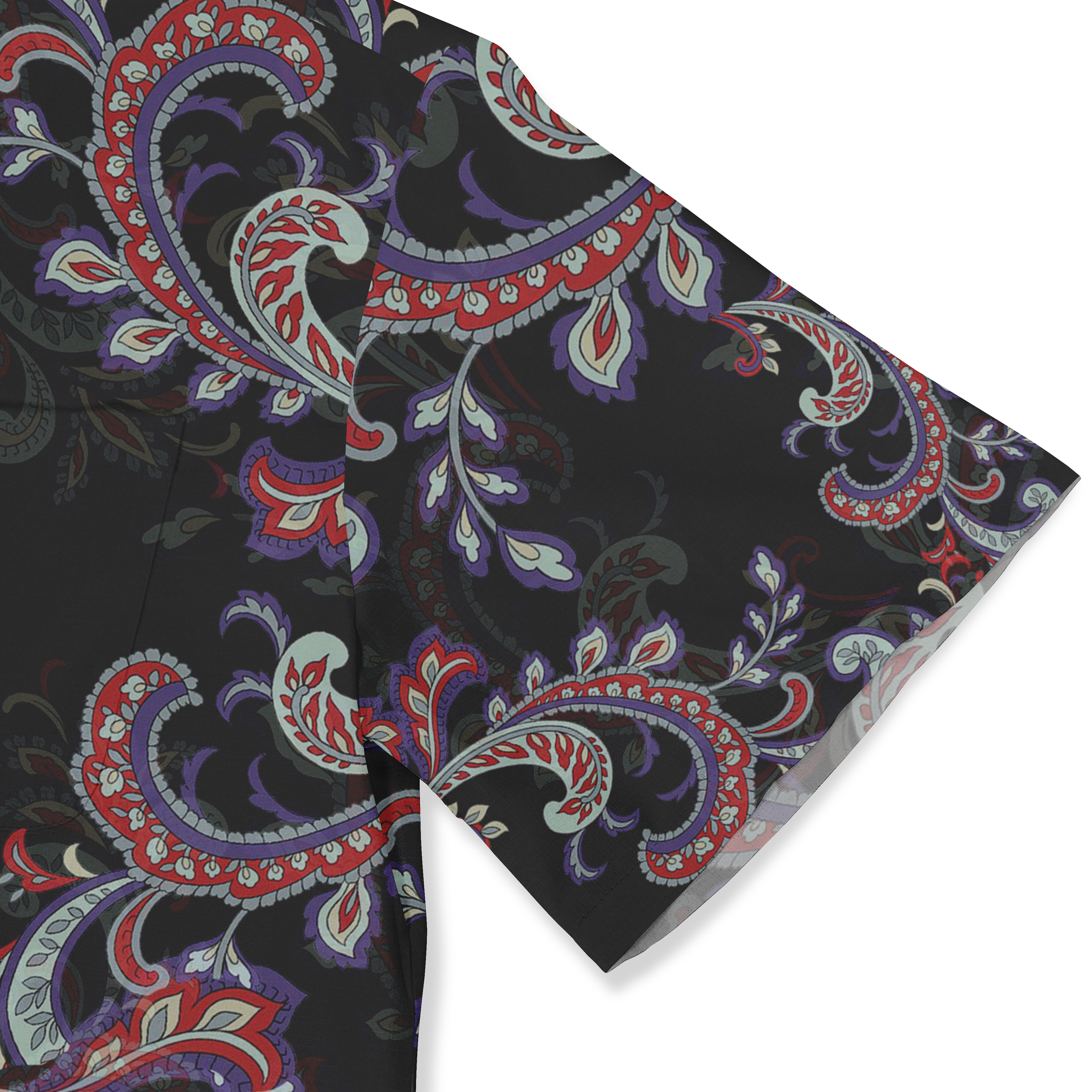 A close-up of a shirt sleeve featuring a vibrant paisley pattern in red, blue, and green on a black background.