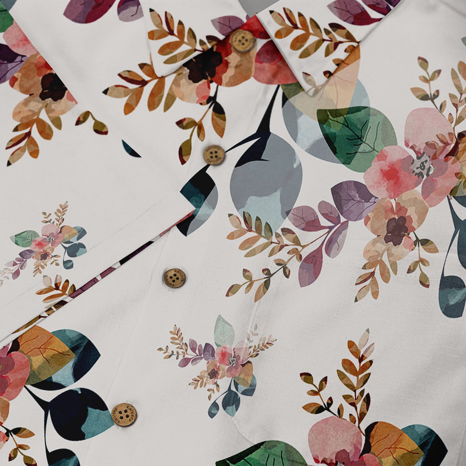 A close-up of the button area of a Hawaiian shirt, highlighting the floral pattern with leaves and flowers in soft shades of pink, green, and brown on a white background, along with wooden buttons that add a natural touch to the design.