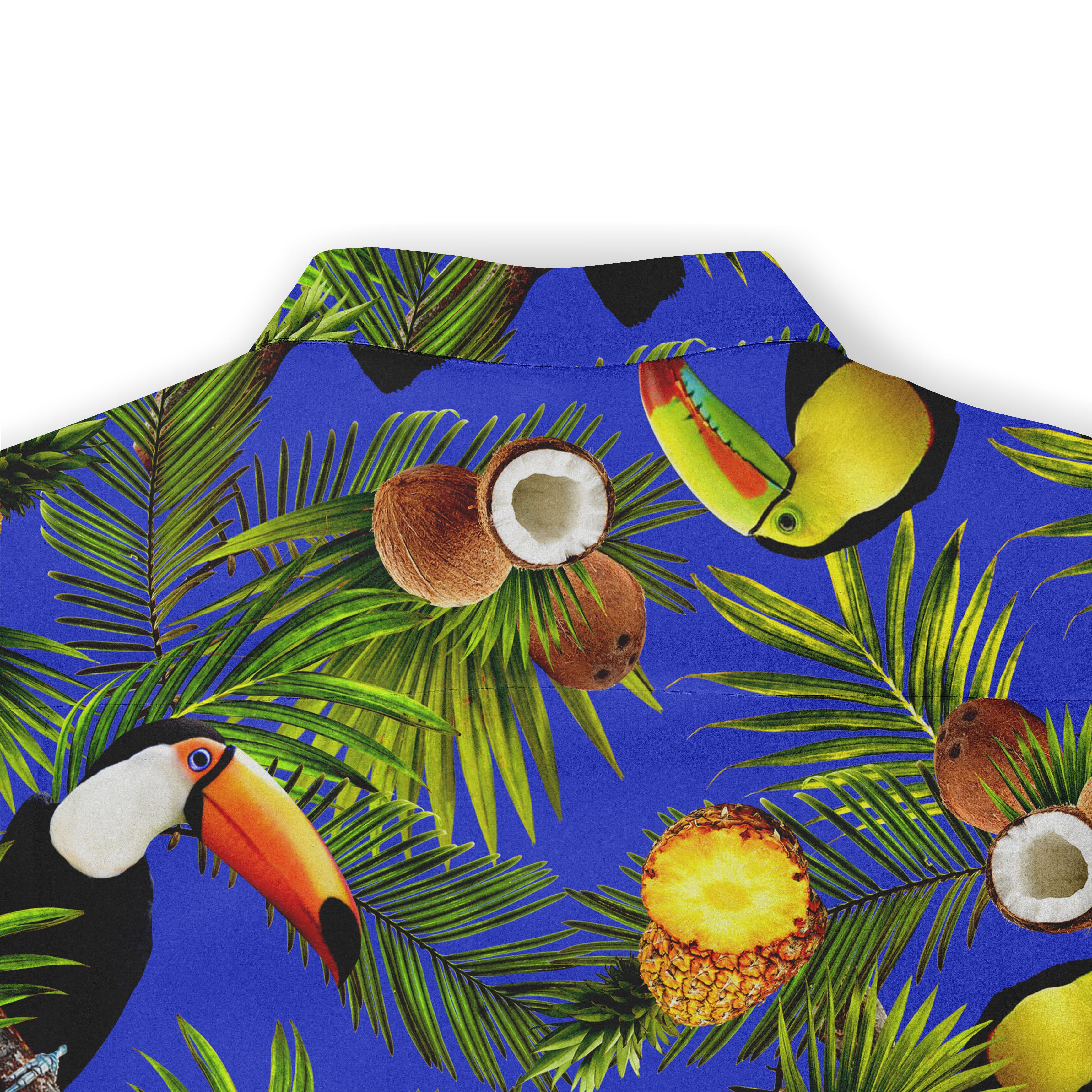 Close-up of the back collar of a Hawaiian shirt, featuring a colorful pattern with toucans, coconuts, pineapples, and palm leaves on a bright blue background.