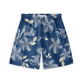 These shorts feature a harmonious floral pattern on a deep blue background, perfect for a stylish and comfortable look. The design blends delicate flowers and leaves, offering a touch of elegance to casual wear.