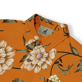 Close-up view of a shirt collar with a floral design featuring white and beige flowers with green leaves on an orange background. The shirt label shows the brand "Kalvero."