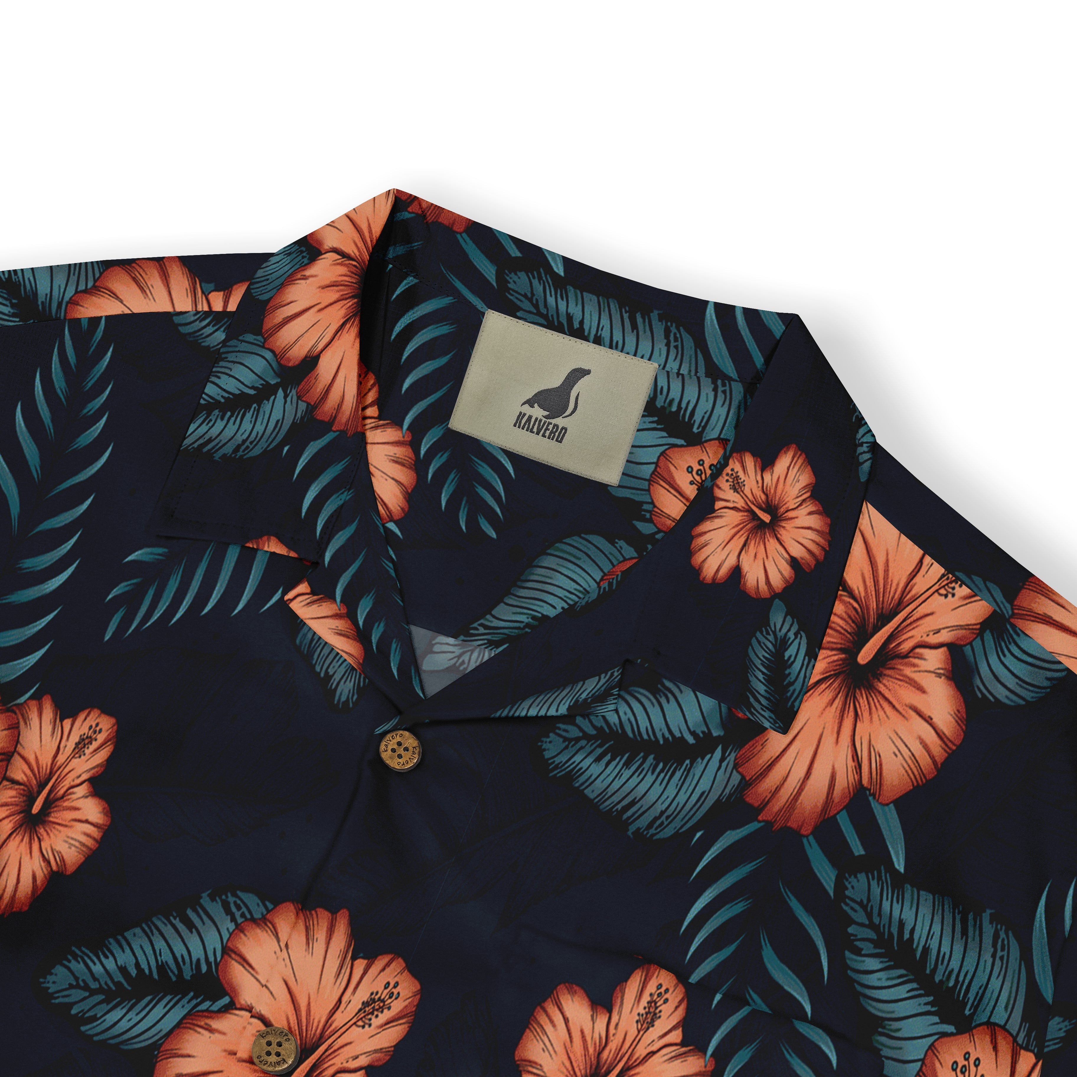 Close-up of a shirt collar with a pattern of orange hibiscus flowers and green leaves on a dark background, featuring a visible &quot;Kalvero&quot; label.