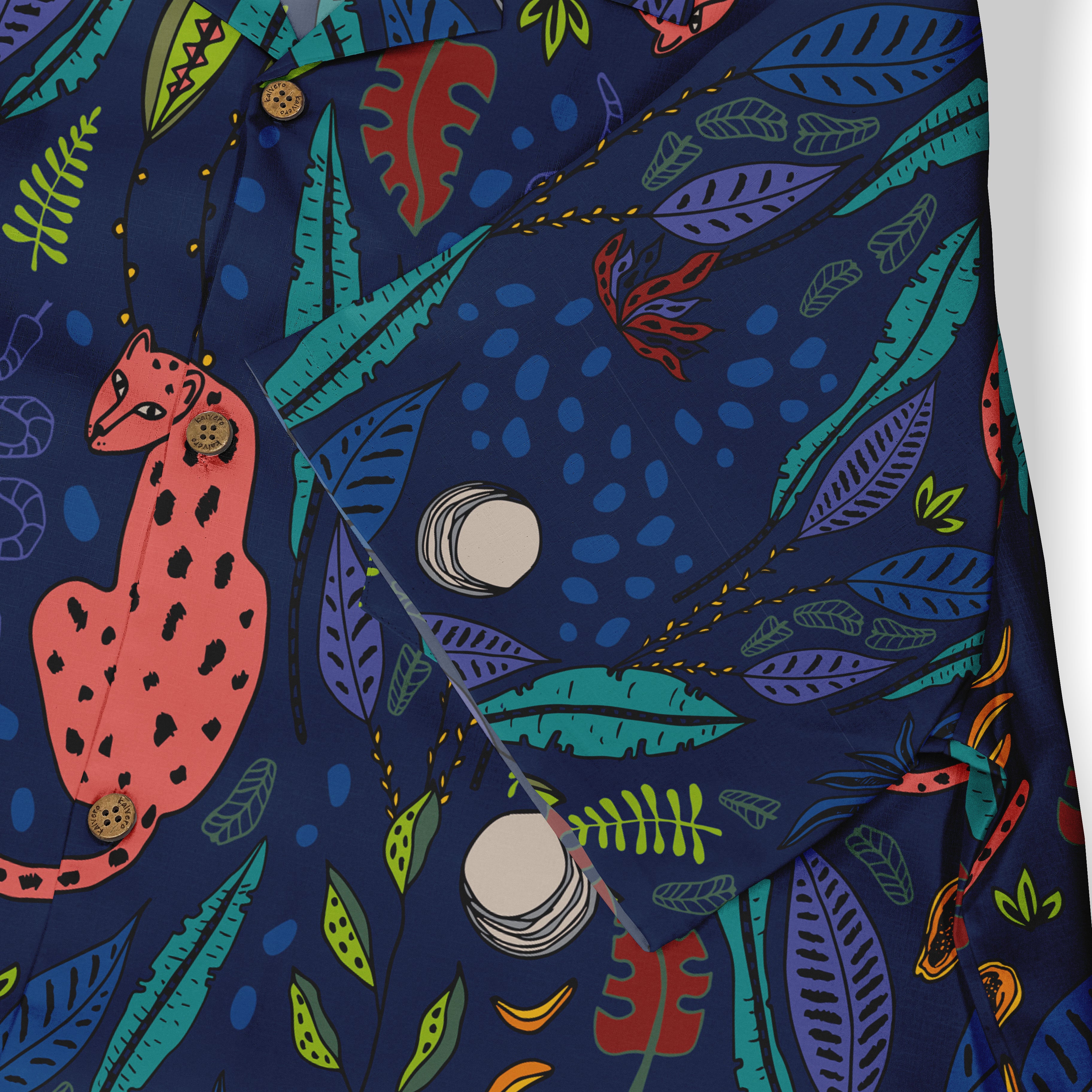 Close-up of a shirt fabric featuring a vibrant design with pink leopards, abstract leaves, and scattered circular shapes on a dark blue background.