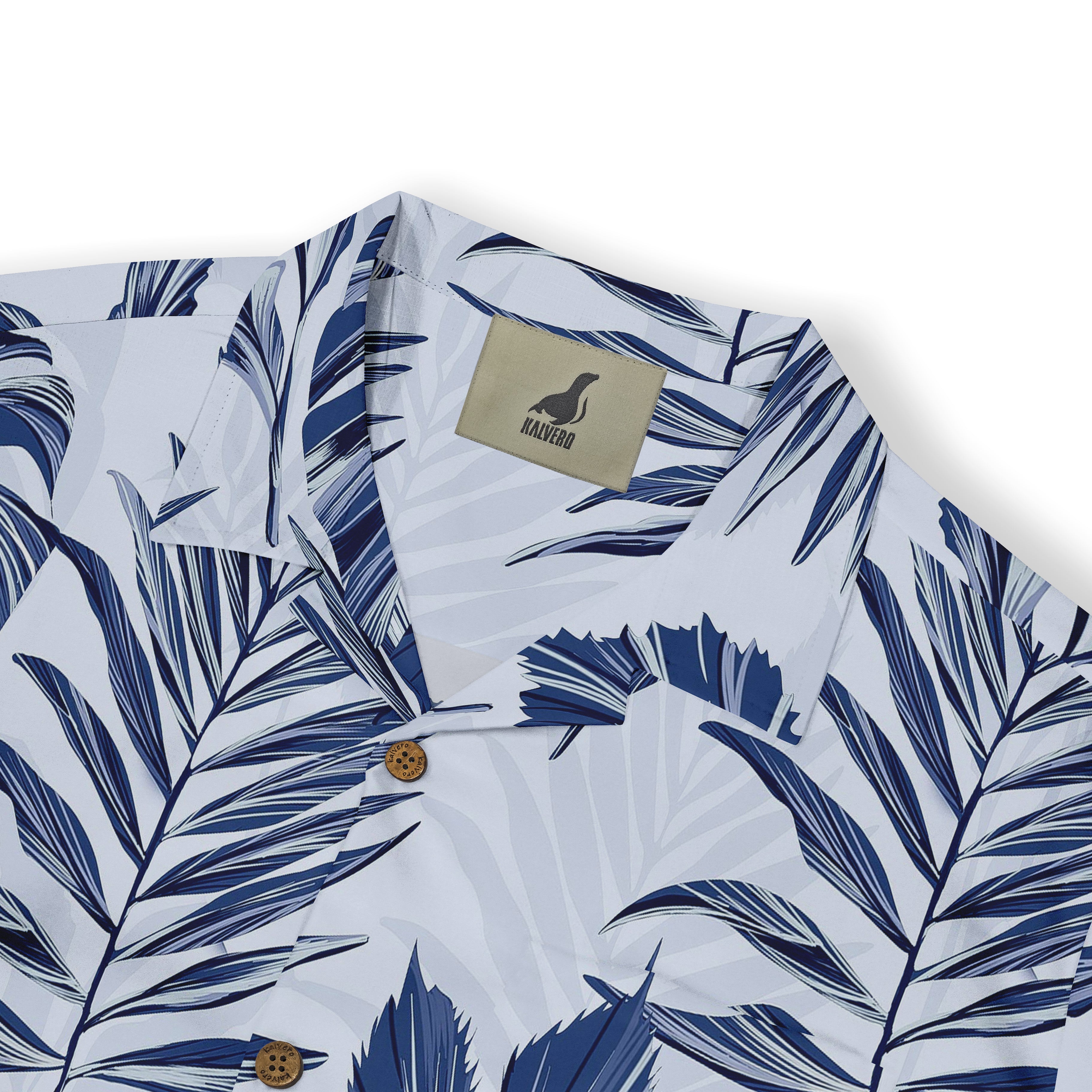 Close-up of the shirt collar with blue tropical leaf patterns, showing the Kalvero label and wooden buttons.