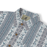 A short-sleeved shirt with a "Serenity Scrolls" pattern, featuring blue and white paisley motifs and floral vines framed by geometric borders front view