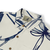 A short-sleeve shirt with a bold abstract floral design in deep blue tones on a crisp white background, offering a fresh and contemporary style.