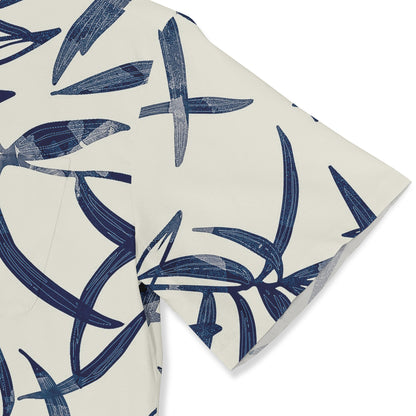 A close-up view of a shirt sleeve featuring an abstract floral design in dark blue tones on a white background, showcasing a modern and artistic style.