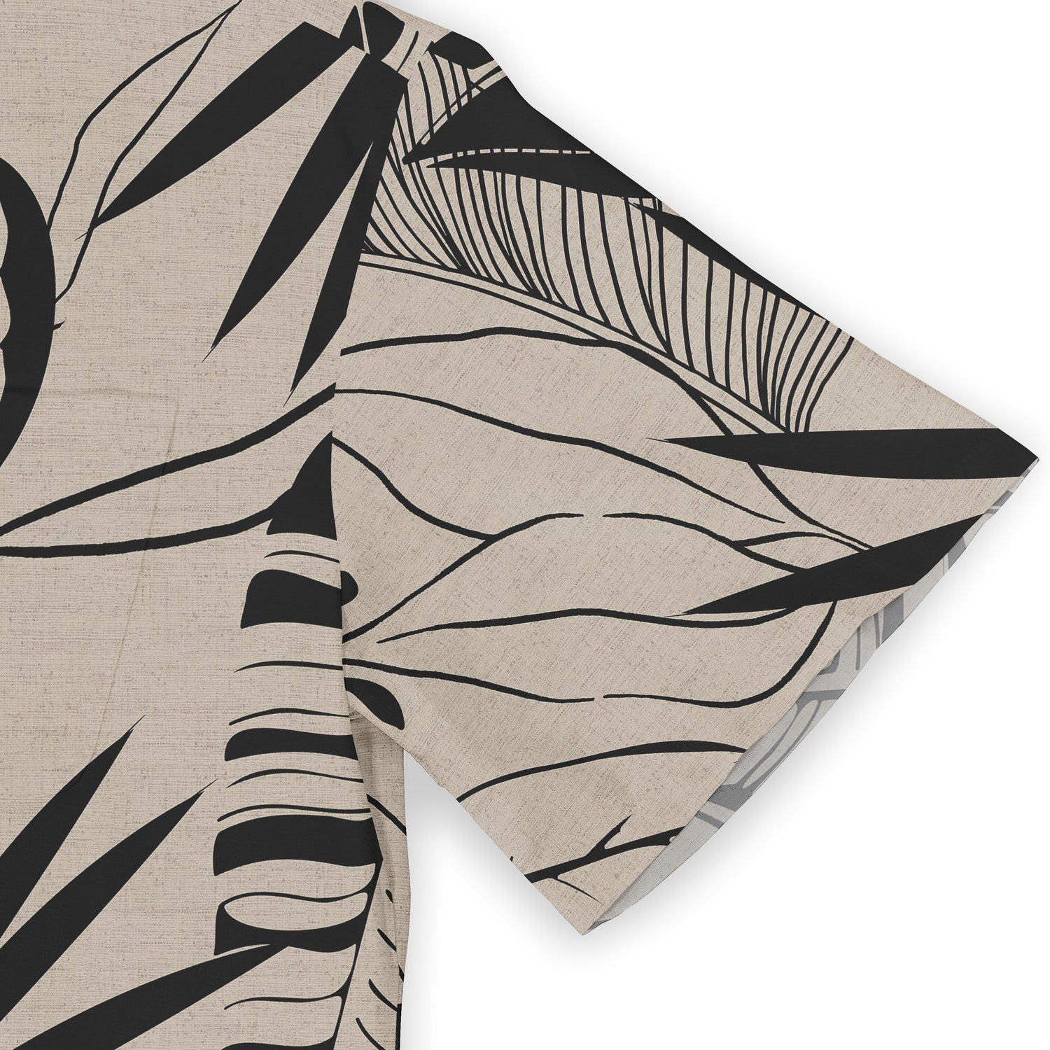 Close-up of a shirt sleeve featuring a striking black and beige leaf design, emphasizing a natural, organic flow with bold, minimalist lines.