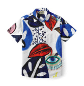 This is a short-sleeve shirt featuring a bold, abstract design with large, vibrant blue and red leaves set against a white background. The pattern includes striking black accents, delicate floral details, and a prominent eye motif, creating a dynamic and eye-catching look.